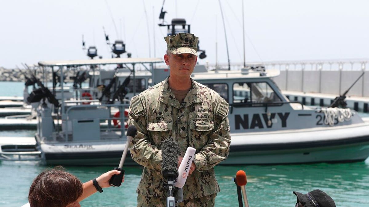 Cmdr. Sean Kido of the U.S. Navy's 5th Fleet talks to journalists at a 5th Fleet Base near Fujairah, United Arab Emirates, Wednesday, June 19, 2019. Cmdr. Kido said Wednesday that damage done last week to the Kokaku Courageous was "not consistent with an external flying object hitting the ship."