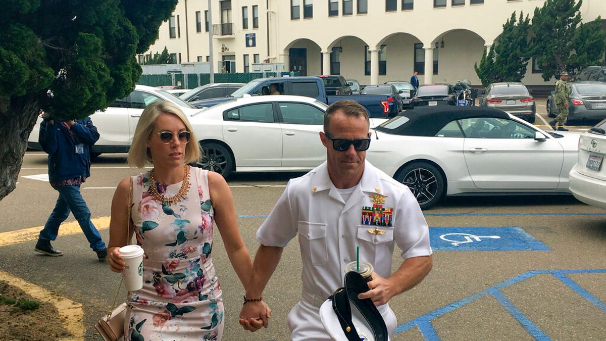 Navy Special Operations Chief Edward Gallagher, right, walks with his wife, Andrea Gallagher, as they arrive to military court on Naval Base San Diego, Thursday, June 20, 2019, in San Diego. (AP Photo/Julie Watson)