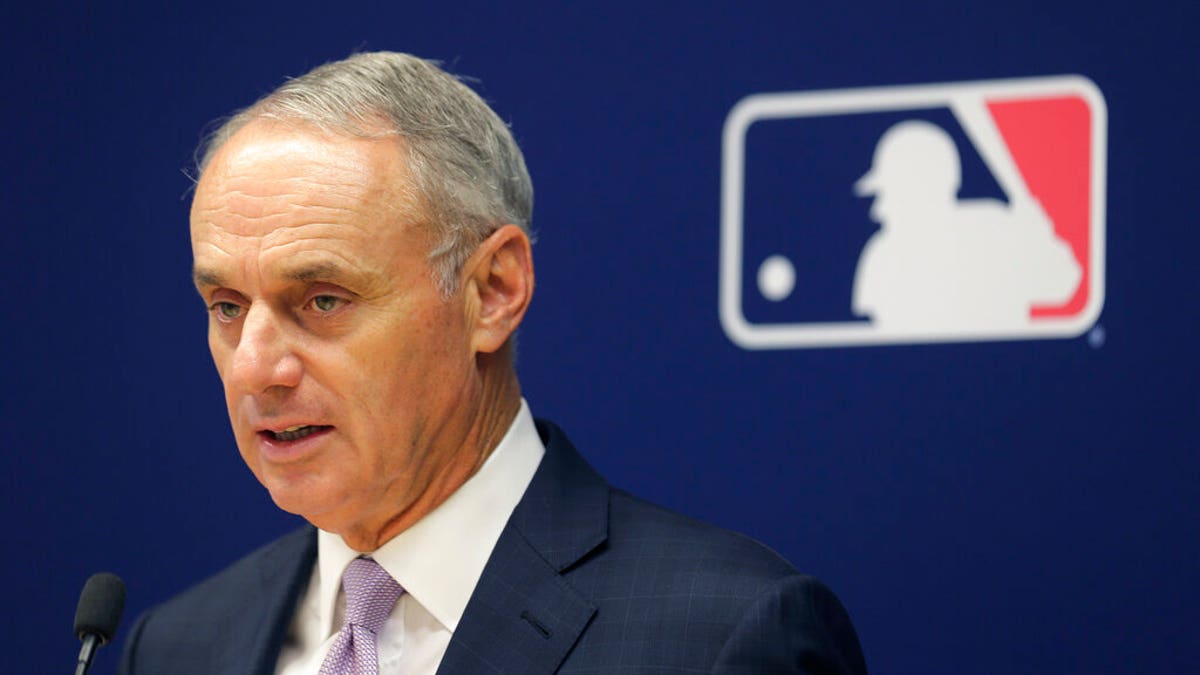 Rob Manfred speaks with reporters