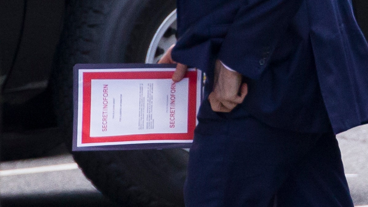 Outgoing Acting Defense Secretary Patrick Shanahan carrying a document labeled secret as he arrived for a meeting with President Trump about Iran at the White House on Thursday.