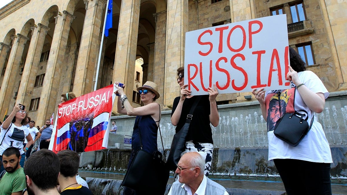 Opposition demonstrators gather in front of Georgian Parliament to call for the resignation of the speaker on Thursday. (AP Photo/Shakh Aivazov)