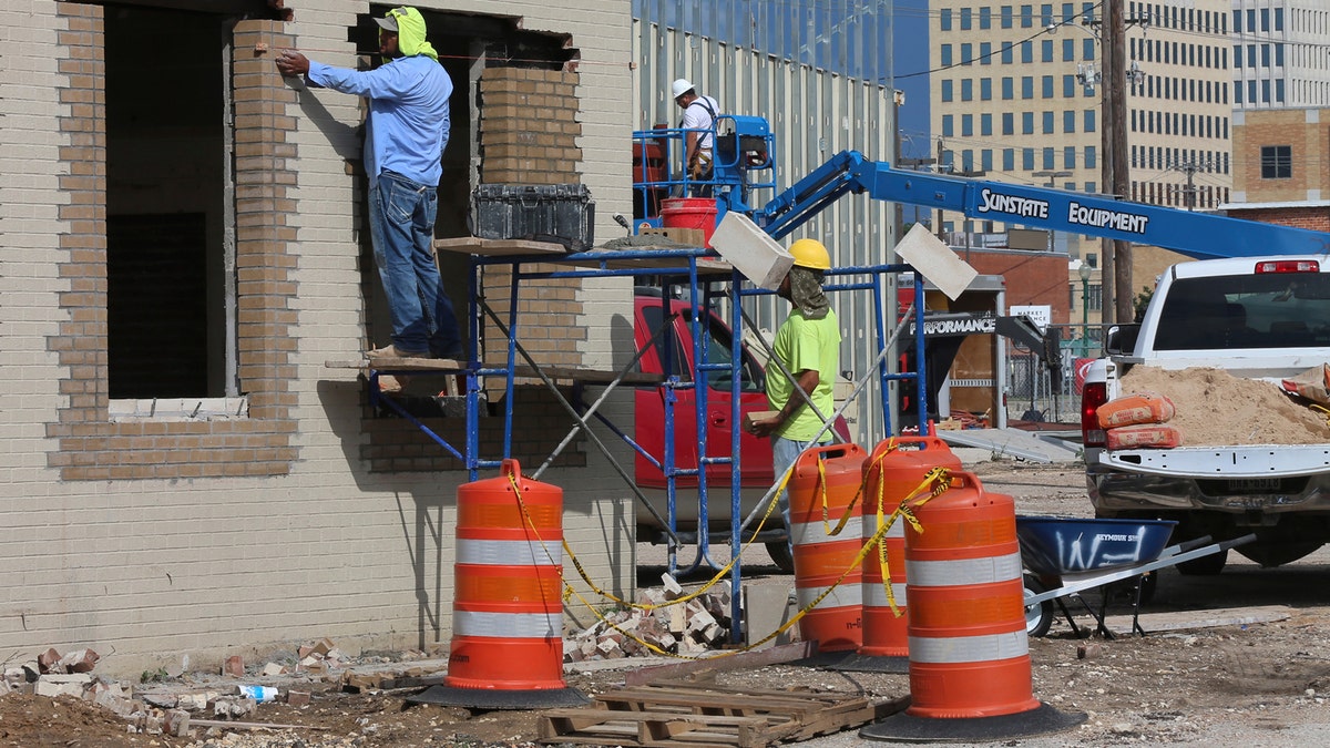 Workers brick in a portion of the new Magnolia Coffee Shop and furniture showroom part of a $10.4 million expansion of Magnolia Market at the Silos.  (Rod Aydelotte/Waco Tribune-Herald via AP)