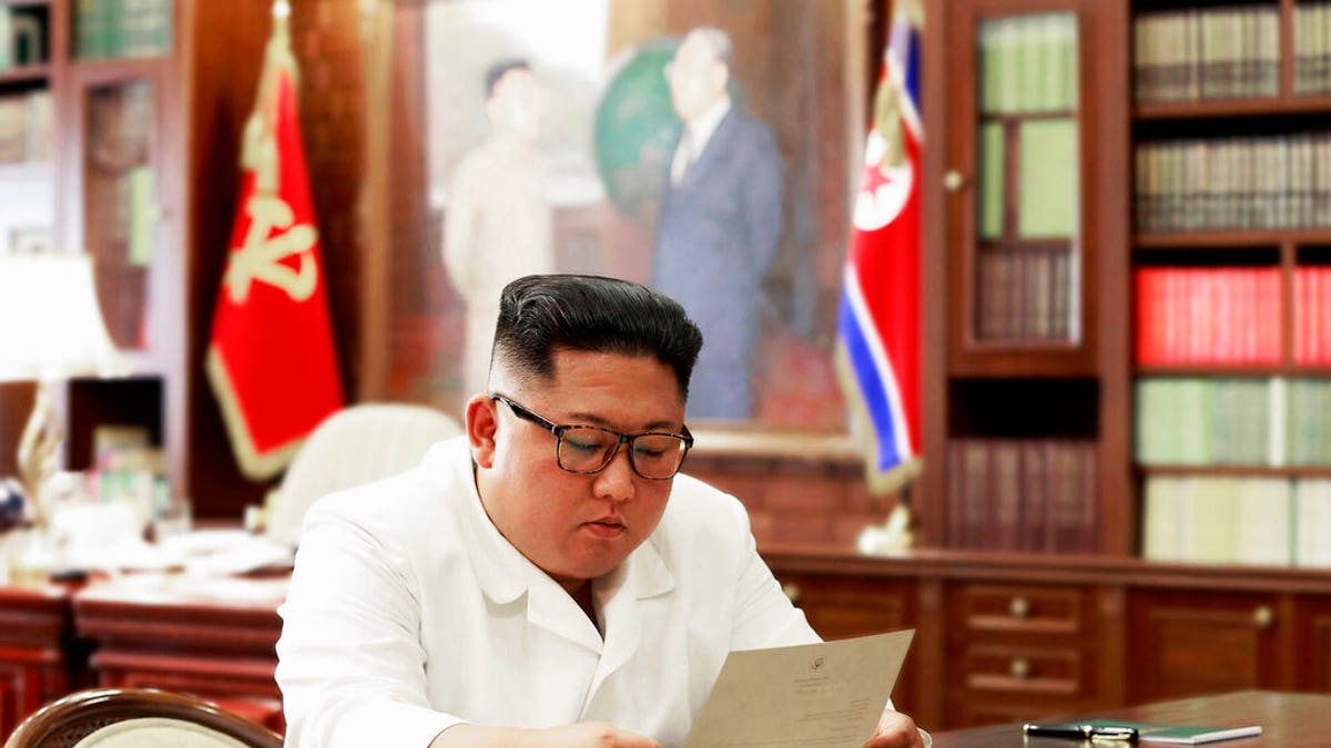 North Korean leader Kim Jong Un reads a letter from U.S. President Donald Trump. (Korean Central News Agency/Korea News Service via AP, File)