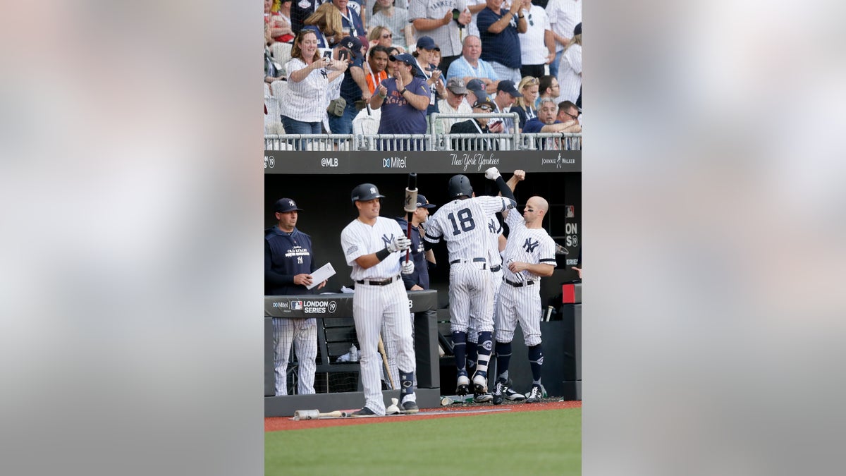 New York Yankees' Didi Gregorius (18) celebrating at the dugout after a home run against the Boston Red Sox during the sixth inning in London on Sunday.
