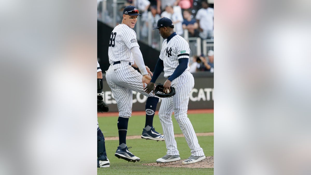 New York Yankees right fielder Aaron Judge, left, and relief pitcher Aroldis Chapman celebrating after their 12-8 win in London on Sunday.