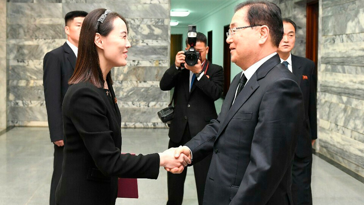 In this photo provided by South Korea Unification Ministry, North Korean leader Kim Jong Un's sister, Kim Yo Jong, a senior official of North Korea's ruling party, left, shakes hands with South Korean presidential national security director Chung Eui-yong, right, at the northern side of the border village of Panmunjom in the Demilitarized Zone, South Korea, Wednesday, June 12, 2019. North Korean leader Kim Jong Un sent flowers and a message of condolence on Wednesday for the funeral of former South Korean first lady Lee Hee-ho, whose late husband held a historic summit with Kim's father in 2000. (South Korea Unification Ministry via AP)