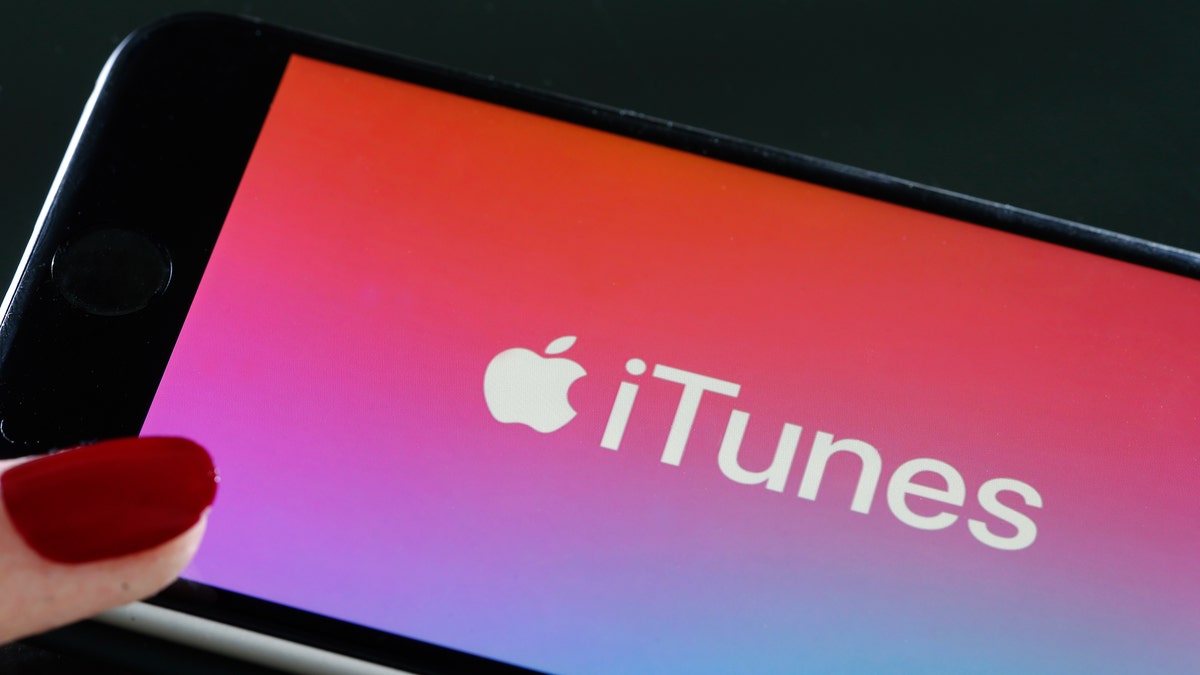 In this photo illustration, the logo of the multimedia application iTunes is displayed on the screen of an Apple iPhone on June 03, 2019 in Paris, France.