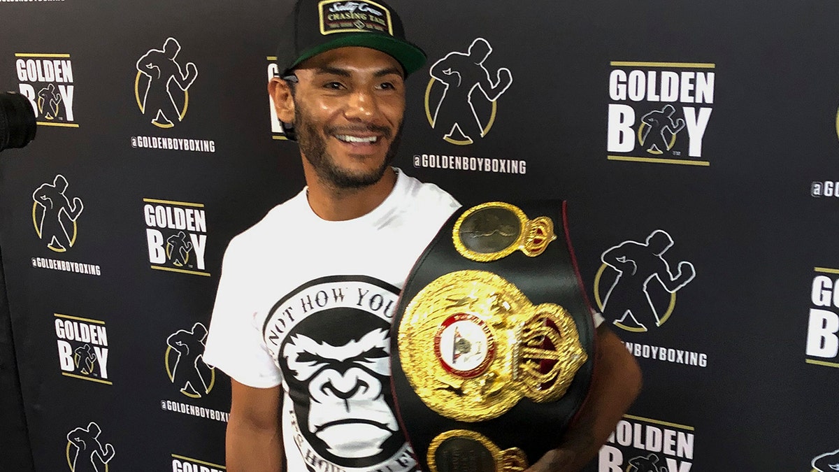 In this Tuesday, June 18, 2019 photo, WBA super featherweight champion Andrew Cancio speaks to reporters at the Westside Boxing Club in Los Angeles. Cancio is a boxing champion who also works for the Southern California Gas Company, and he plans to keep his day job even after his lucrative rematch with Alberto Machado in Indio, Calif. (AP Photo/Greg Beacham)