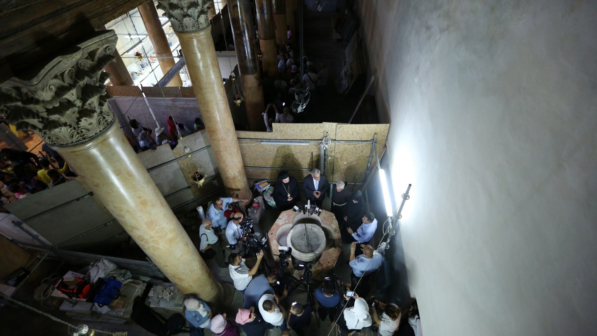Palestinian Minister and Head of Restoration Commission for Church of the Nativity, Ziad al-Bandak (C) holds a press conference on the discovery of a baptismal font at the Church of the Nativity in Bethlehem, West Bank on June 22, 2019.