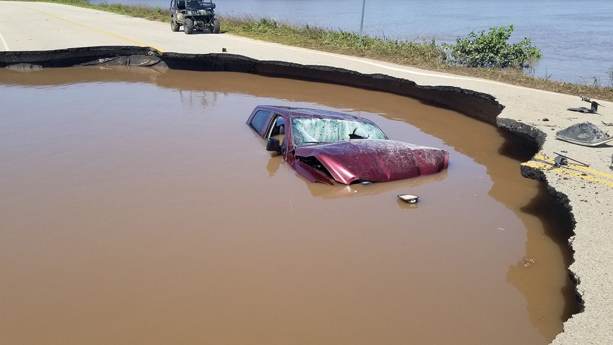 The driver ended up in the sinkhole after driving through two sets of roadblocks.