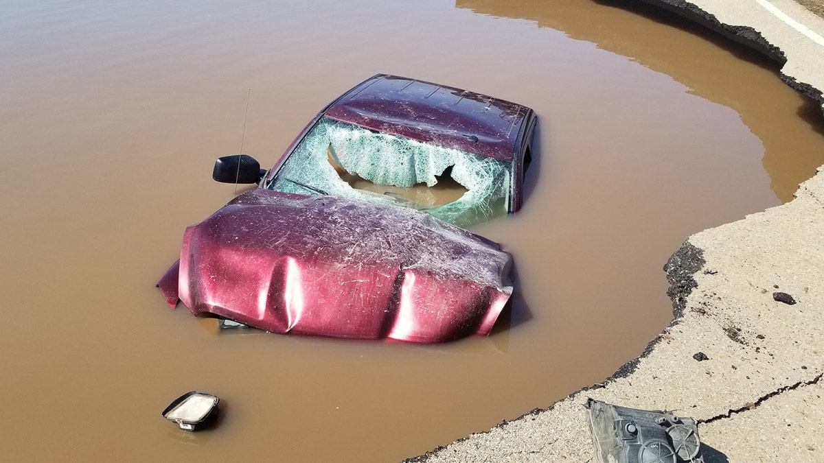 Damage to the vehicle can be seen after the driver went through roadblocks set up for flooding.