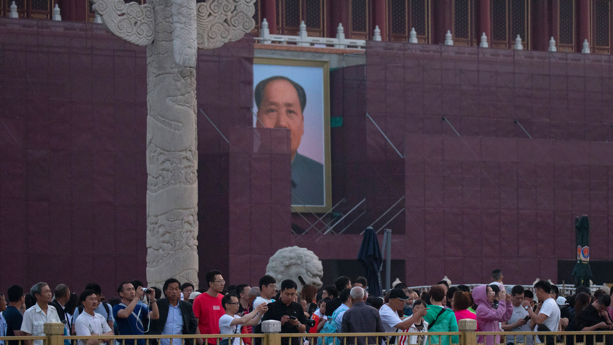 Visitors gather to watch the flag raising in front of Mao Zedong's portrait on Tiananmen Gate on the 30th anniversary of a bloody crackdown of pro-democracy protesters in Beijing on Tuesday, June 4, 2019. Critics say the 1989 Tiananmen crackdown, which left hundreds, possibly thousands, dead, set the ruling Communist Party on its present course of ruthless suppression, summary incarceration and the frequent use of violence against opponents in the name of 