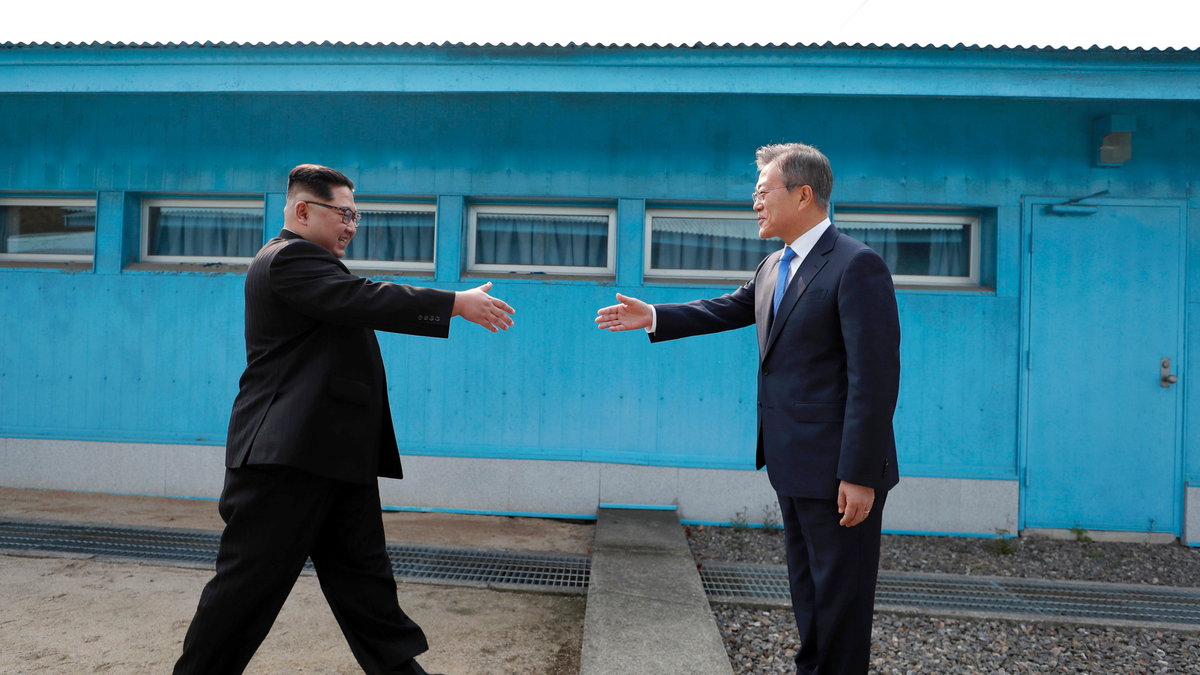 North Korean leader Kim Jong Un, left, prepares to shake hands with South Korean President Moon Jae-in over the military demarcation line in 2018. <br data-cke-eol="1">
(Korea Summit Press Pool via AP, File)