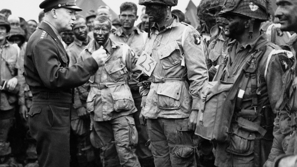 In this June 6, 1944, file photo, U.S. Gen. Dwight D. Eisenhower, left, gives the order of the day to paratroopers in England prior to boarding their planes to participate in the first assault of the Normandy invasion. (U.S. Army Signal Corps via AP)