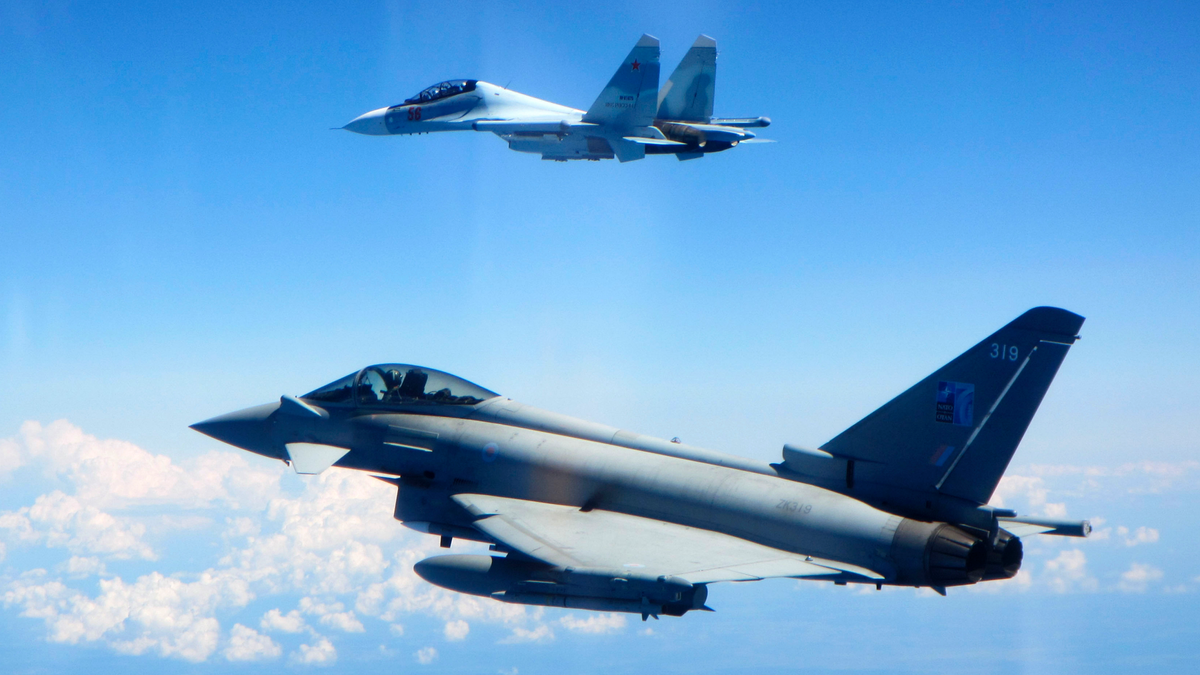 CAPTION CORRECTS AIRCRAFT NAME - In this photo taken on Saturday, June 15, 2019, a Royal Air Force Typhoon jet, bottom, flies by a Su-30 Flanker fighter. Two Royal Air Force jets deployed in Estonia have been scrambled twice in recent days, bringing the number of intercepts of Russian aircraft to eight since taking over the Baltic Air Policing mission in early May. The Typhoon jets were alerted Friday to intercept a Russian Su-30 Flanker fighter, and passed a military transport craft as it was escorting the fighter over the Baltic Sea. In a second incident on Saturday, RAF crews intercepted a Su-30 Flanker fighter and an Ilyushin Il-76 Candid transport aircraft that was traveling north from the Russian enclave of Kaliningrad toward Estonian and Finnish airspace. (UK Ministry of Defence via AP)