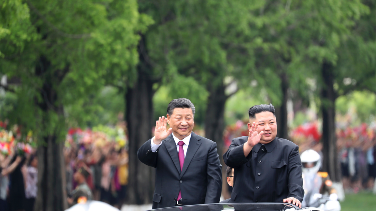 In this Thursday, June 20, 2019, photo released by China's Xinhua News Agency, visiting Chinese President Xi Jinping, left, and North Korean leader Kim Jong Un wave from an open top limousine as they travel along a street in Pyongyang, North Korea. (Associated Press)