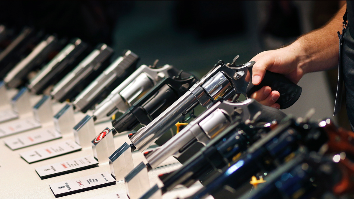 Handguns are displayed at the Smith &amp; Wesson booth at the Shooting, Hunting and Outdoor Trade Show in Las Vegas. (AP Photo/John Locher, File)