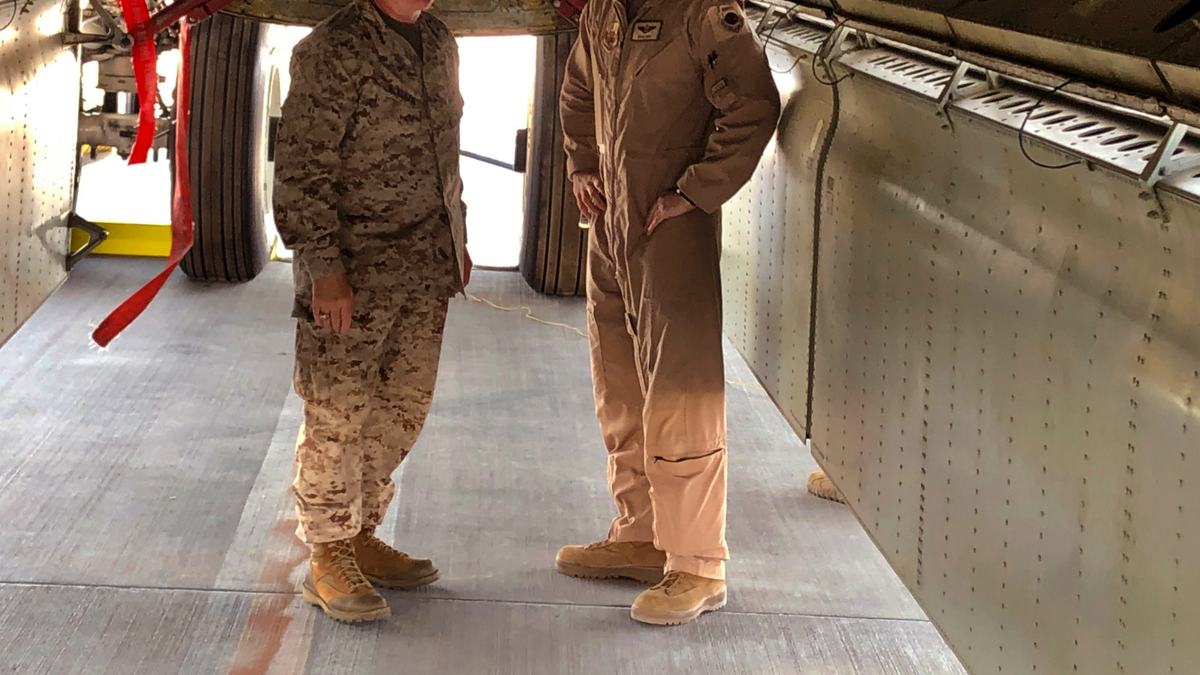 Marine Gen. Frank McKenzie, head of U.S. Central Command, confers with an Air Force officer below the bomb bay of a B-52 bomber on Friday, June 7, 2019 at al-Udeid air base in Qatar. (AP Photo/Robert Burns)
