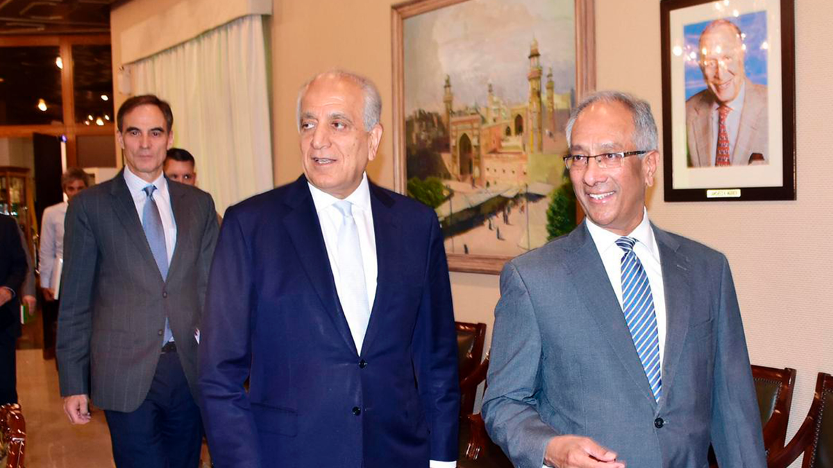 In this photo released by the Foreign Office, Pakistan's Foreign Ministry official Aftab Khokhar, right, escorts visiting Special Representative for Afghanistan Reconciliation Zalmay Khalilzad, center, for talks at the Foreign Office in Islamabad, Pakistan, Sunday, June 2, 2019. Khalilzad has met Pakistani officials to find a peaceful solution to neighboring Afghanistan's war.