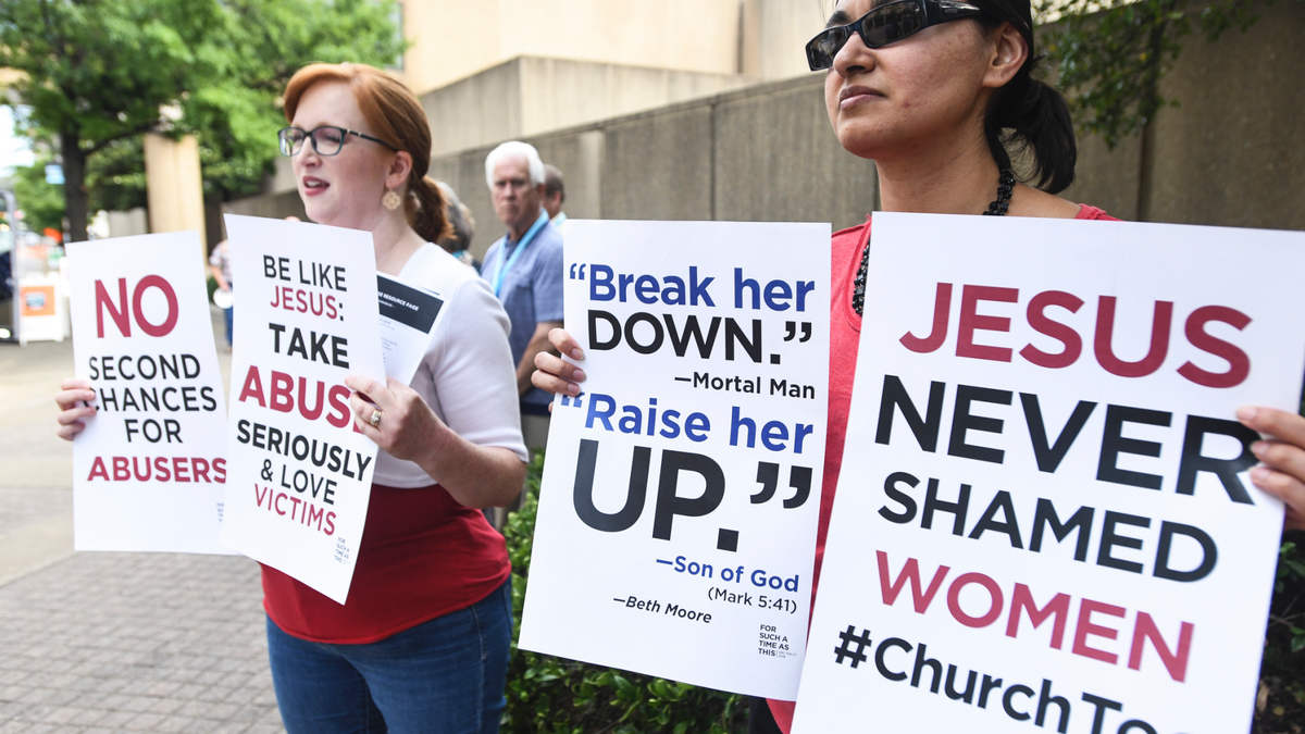 Jennifer Weed, left, and Nisha Virani, both of Birmingham, Ala., demonstrate outside Southern Baptist Convention's annual meeting Tuesday, June 11, 2019, during a rally in Birmingham, Ala. The For Such A Time As This protest calls for a change in the way the SBC views and treats women and demands action to combat sexual abuse within the establishment. (AP Photo/Julie Bennett)