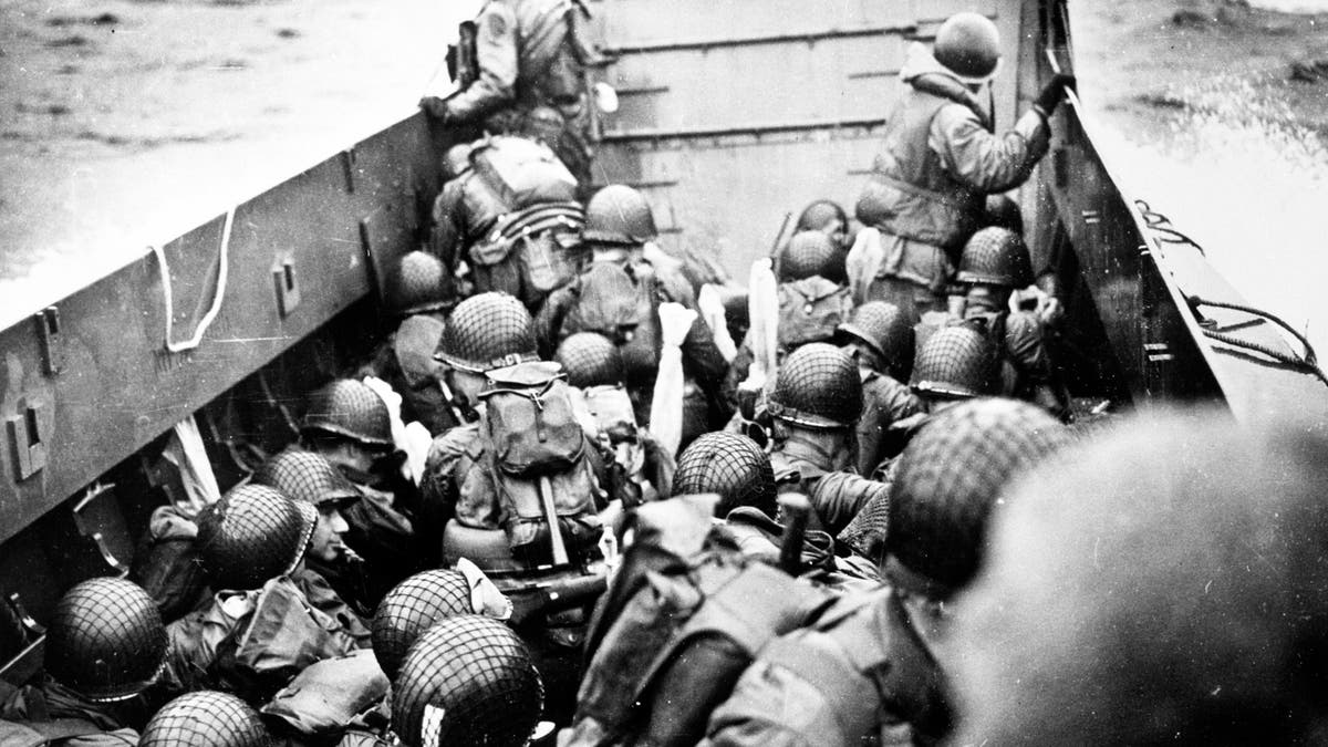 Troops crouch inside a LCVP landing craft, just before landing on Omaha Beach on D-Day, 6 June 1944. Photograph from the U.S. Coast Guard Collection in the U.S. National Archives.