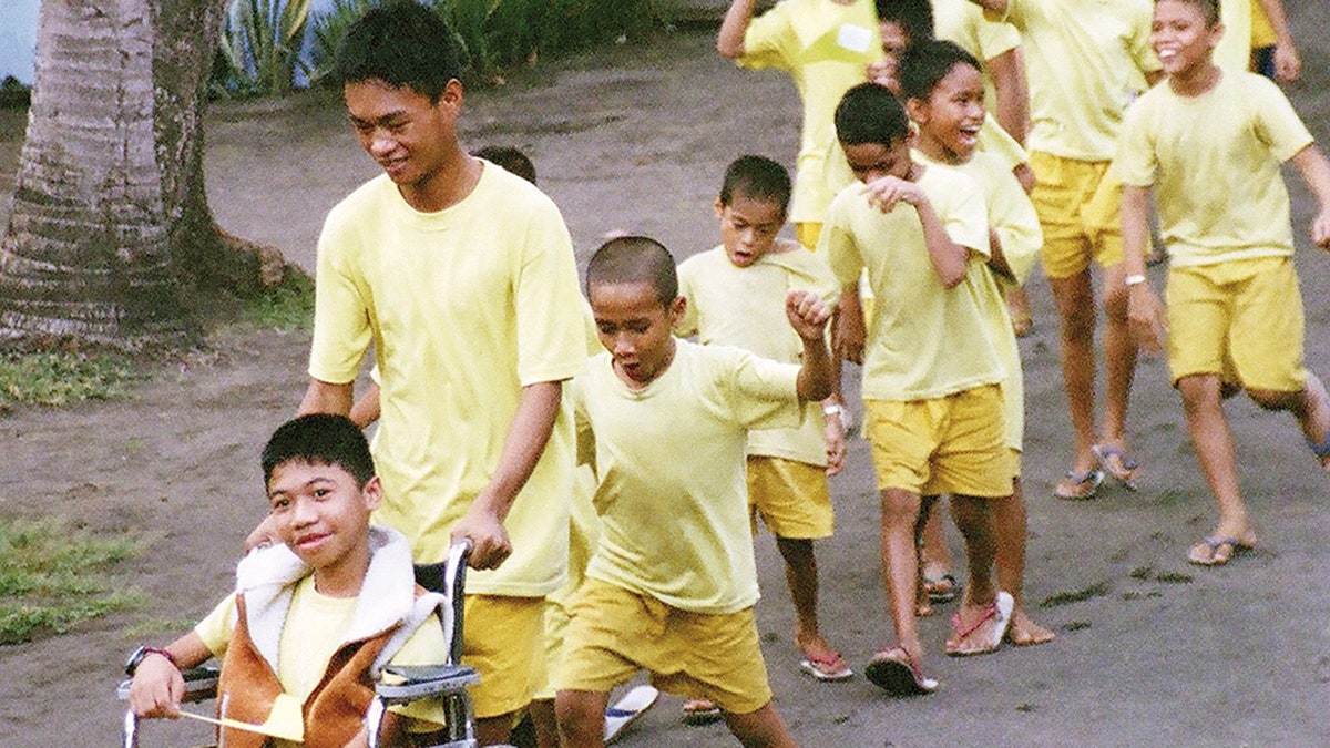 Darwin Ramos in a wheelchair with his friends of Our Lady of Guadalupe Center during Tulay ng Kabataan summer camp in 2008.