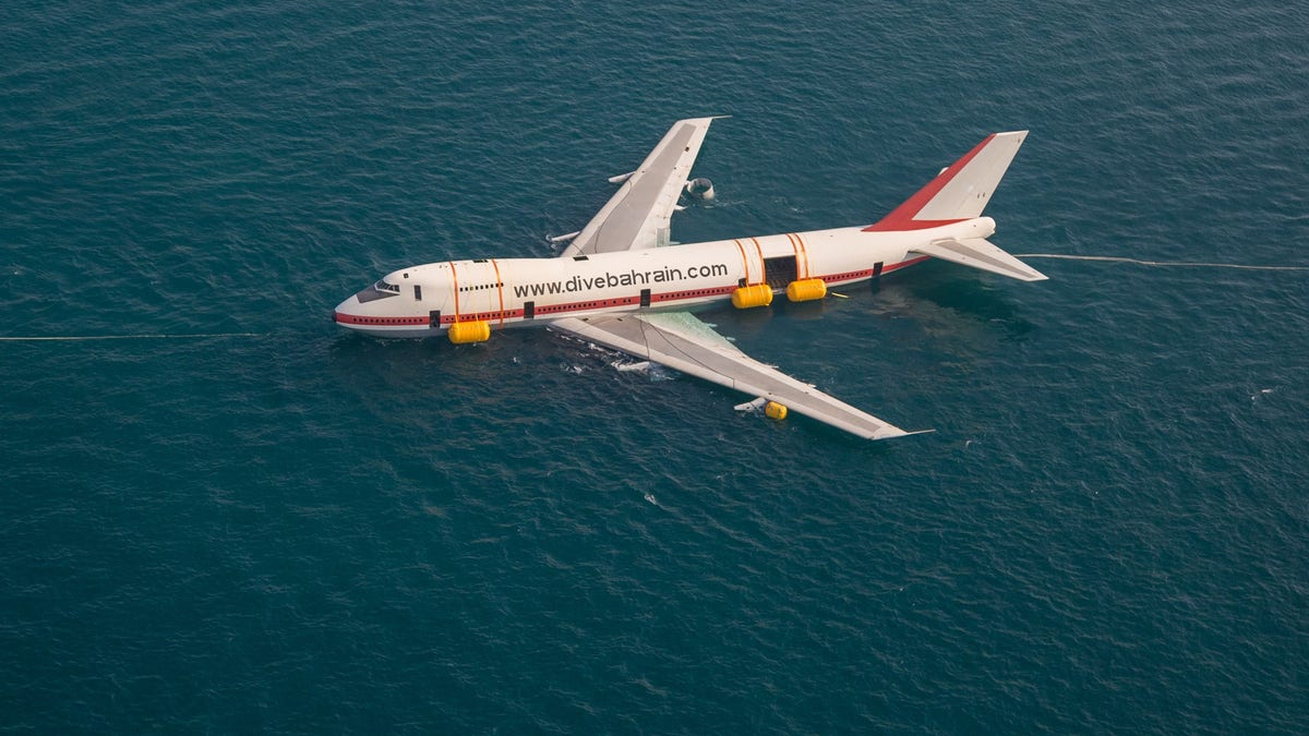 The Boeing 747 was towed out to sea to be sunk as part of what's being called an eco-friendly project.