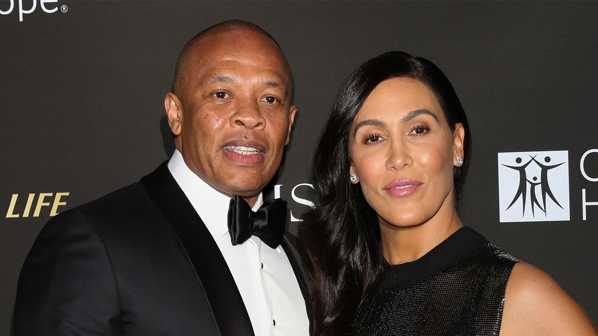 Rapper and music producer Dr. Dre, left, and his wife Nicole Young, right, attend the City Of Hope Gala on October 11, 2018, in Los Angeles, Calif. 