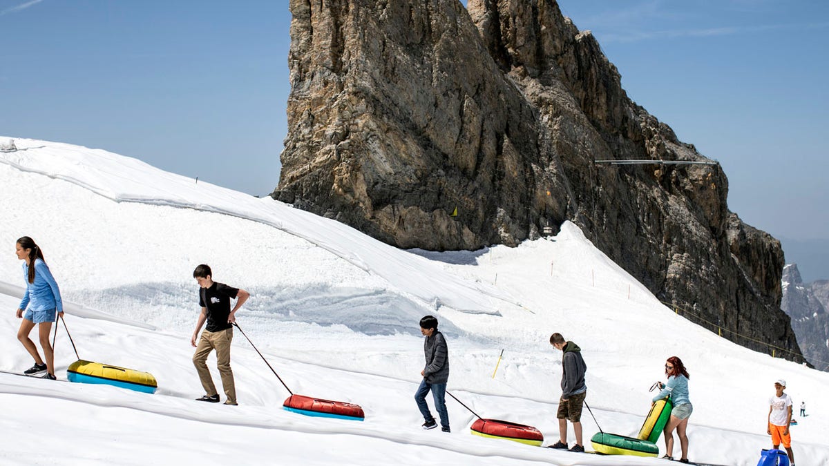 Tourists enjoy the summer temperatures on the Titlis mountain, on Wednesday, June 26, 2019, near Engelberg, Switzerland. All over Europe is hit by a heatwave.
