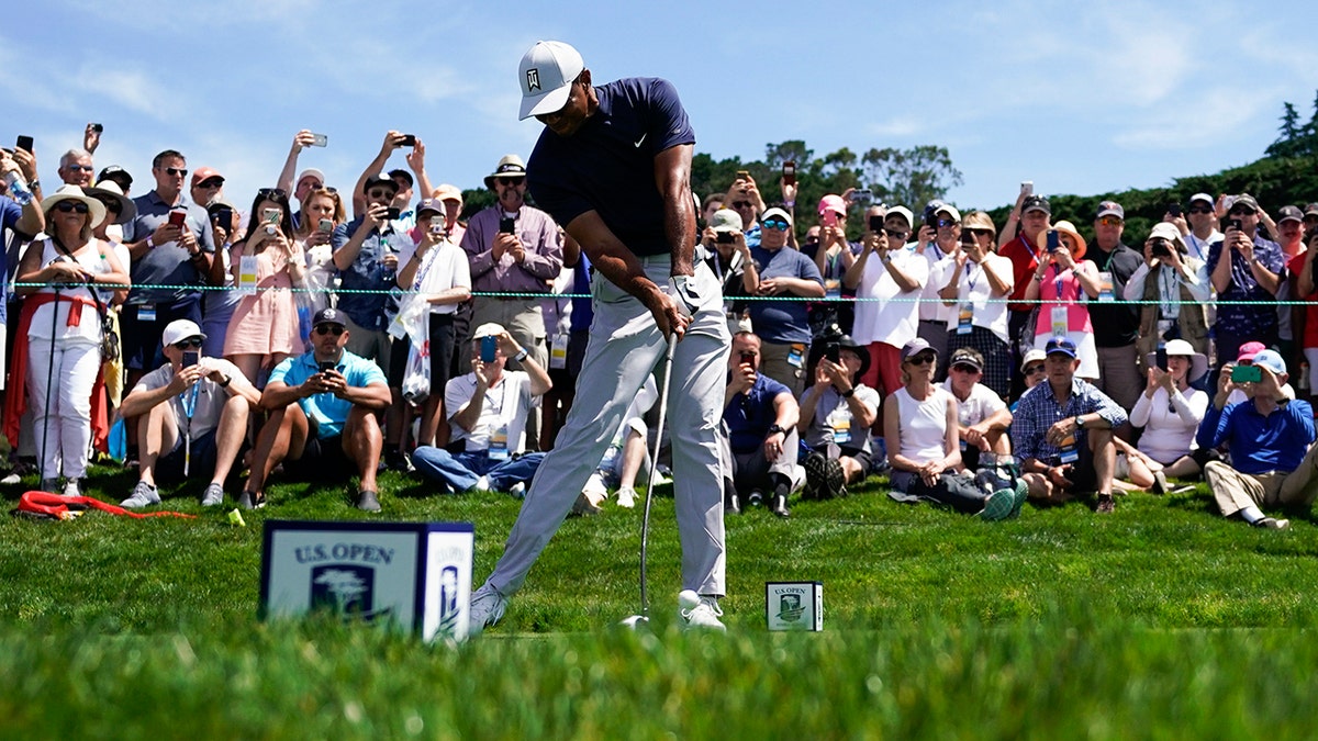 Tiger Woods tees off