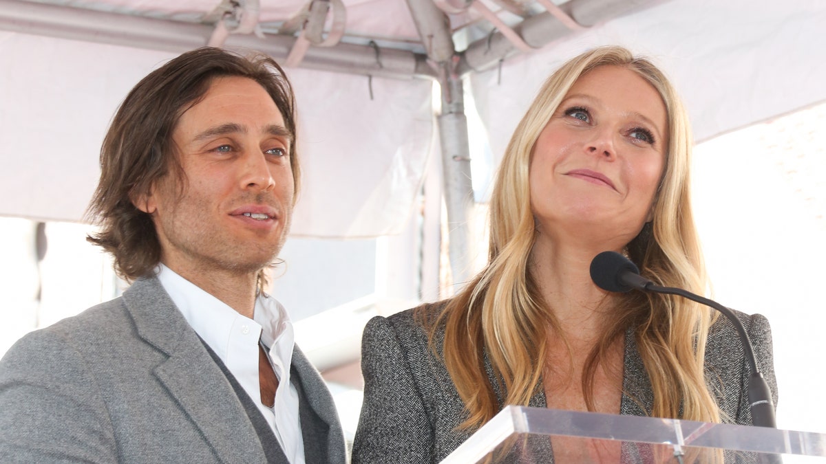 HOLLYWOOD, CALIFORNIA - DECEMBER 04: Writer Brad Falchuk (L) and Actress Gwyneth Paltrow (R) attend the ceremony honor Ryan Murphy with a Star on The Hollywood Walk Of Fame on December 04, 2018 in Hollywood, California.