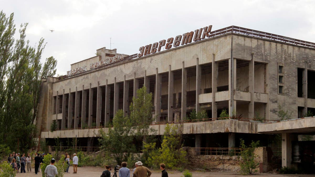 Visitors look in the abandoned city of Pripyat, near the Chernobyl nuclear power plant, in June 2019. Tourist companies in the area have reported a sharp increase in the number of bookings since HBO's "Chernobyl" debuted.