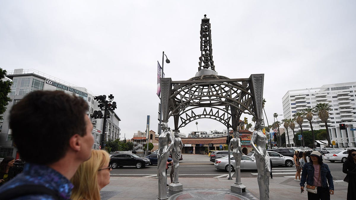 Tourists stop to look at the "Ladies of Hollywood Gazebo" on the Hollywood Walk of Fame in Hollywood, California, June 18, 2019. - A statue of Marilyn Monroe which is normally perched atop the gazebo's Eiffel Tower-shaped structure was stolen on June 16. (Getty Images)