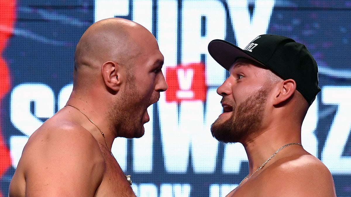 Boxers Tyson Fury, left, and Tom Schwarz face off during a ceremonial weigh-in at MGM Grand Garden Arena on June 14, 2019 in Las Vegas. (Getty Images)
