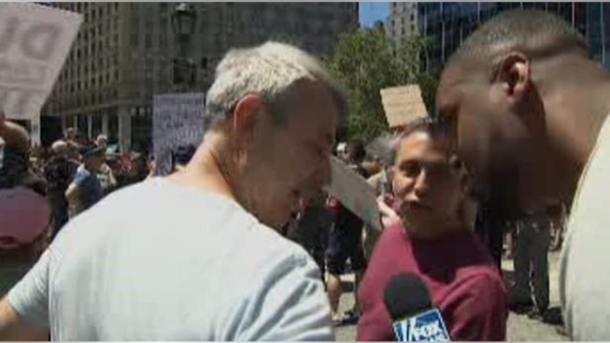 Lawrence Jones confronting two men who made racist remarks to him Saturday at an anti-Trump rally in Lower Manhattan.