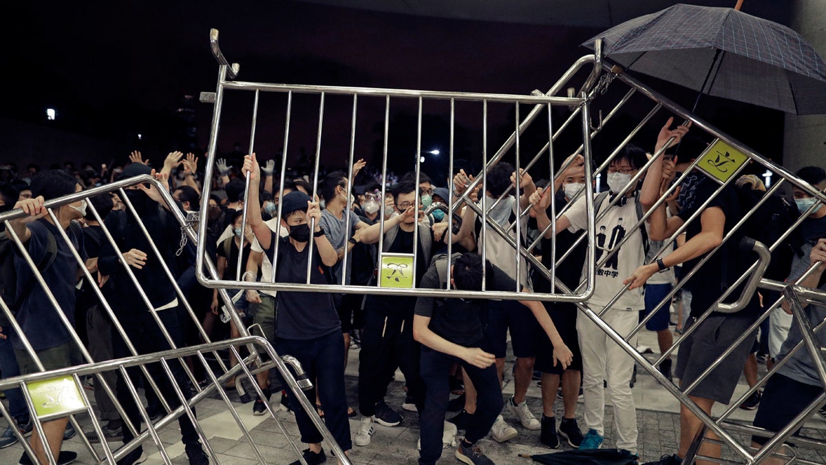 Protesters use barriers against the proposed amendments to the extradition law at the Legislative Council in Hong Kong during the early hours of Monday, June 10, 2019.