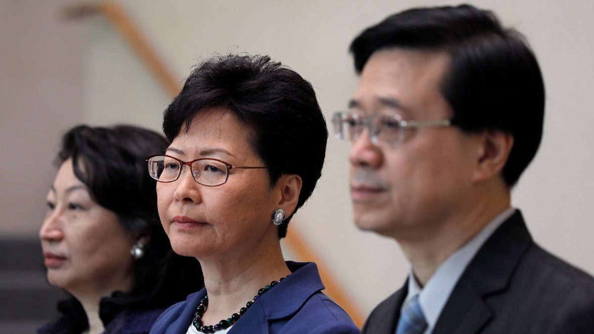Hong Kong Secretary for Security John Lee, right, Hong Kong Chief Executive Carrie Lam, center, and Secretary of Justice Teresa Cheng listen to reporters questions during a press conference in Hong Kong Monday, June 10, 2019.