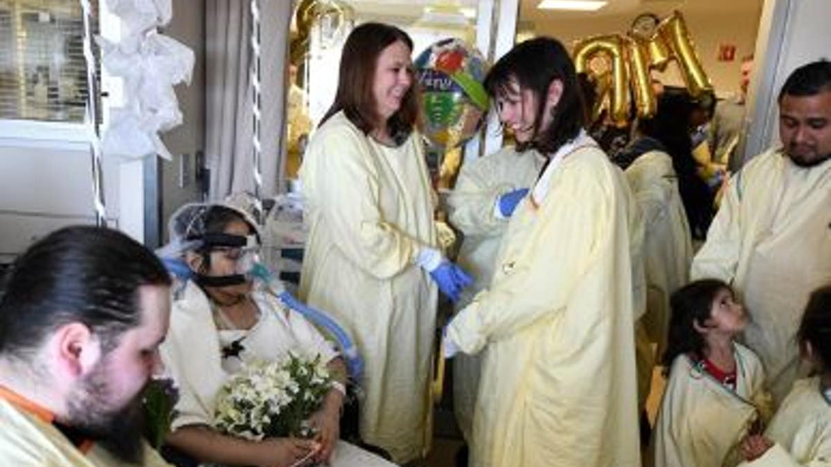 Indiana University Health hospital staffers and relatives of Anna Gonzales gathered for her wedding to fiance Justin Middleton.