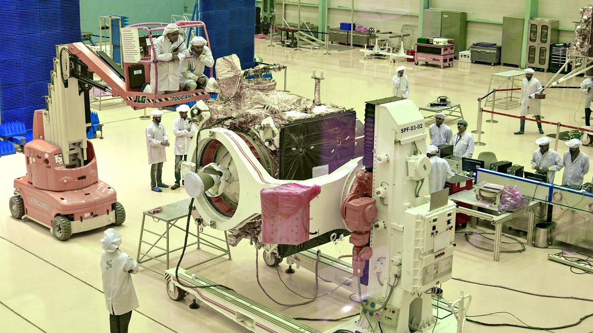Scientists work on the Chandrayaan-2 orbiter vehicle in Bangalore on June 12, 2019.