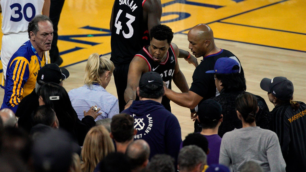 Lowry confronts Warriors fans after the shove by part-owner Mark Stevens in the fourth quarter of Game 3 of the NBA Finals. (AP Photo/Tony Avelar)