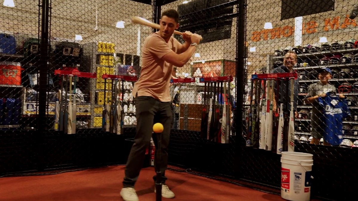 Cody Bellinger takes a few swings in the cage at DICK'S Sporting Goods in Tustin, Calif.
