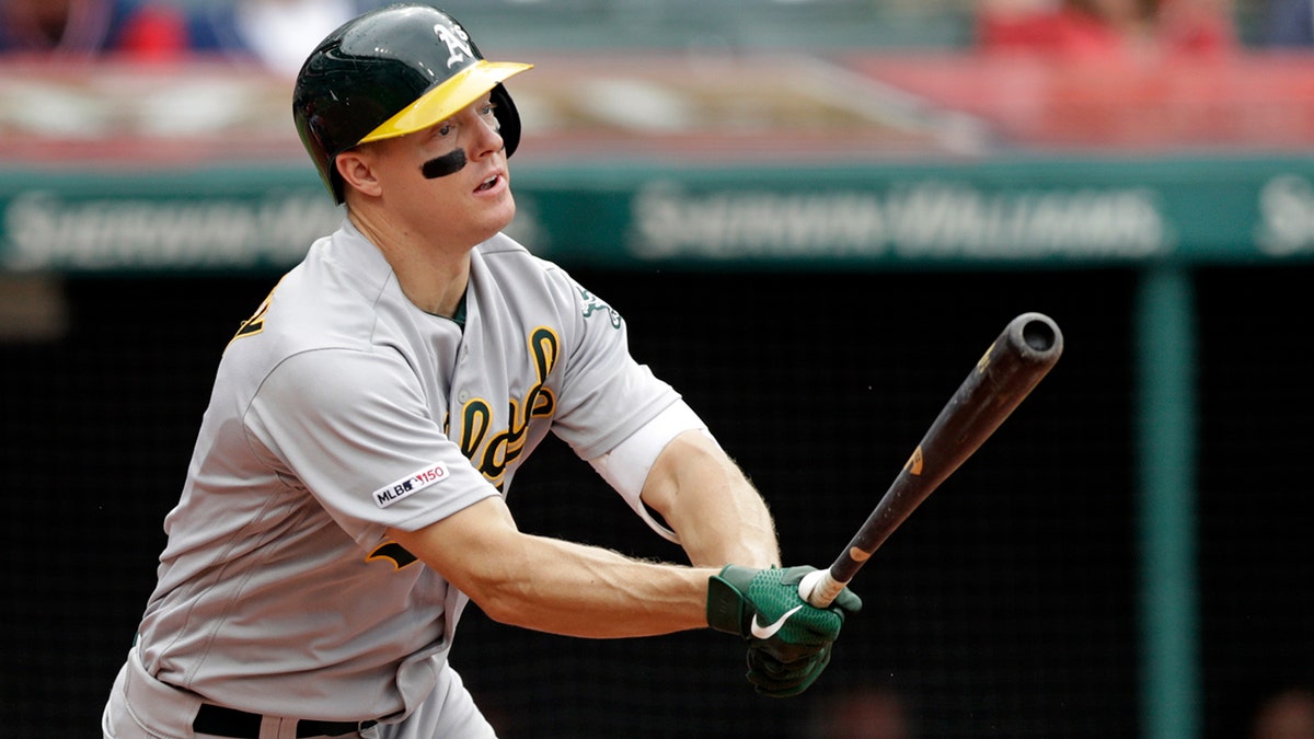 FILE - In this May 22, 2019, file photo, Oakland Athletics' Nick Hundley watches his ball after hitting a one-run double off Cleveland Indians relief pitcher Tyler Clippard in the seventh inning of a baseball game in Cleveland. Five years ago, Hundley visited Children’s Hospital of Wisconsin and met a young man named Zach who sure needed a lift as he fought his battle with leukemia. (AP Photo/Tony Dejak, File)