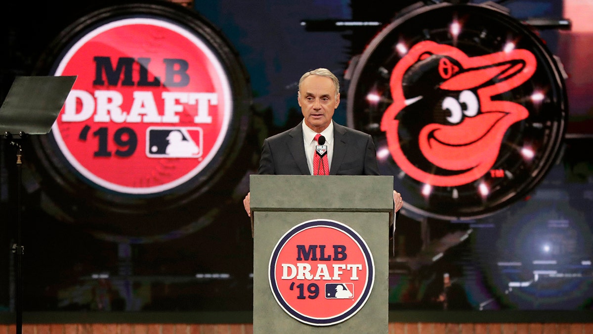 Major League Baseball Commissioner Rob Manfred announces Adley Rutschman, a catcher from Oregon State University, as the No. 1 selection by the Baltimore Orioles in the first round of the Major League Baseball draft, Monday, June 3, 2019, in Secaucus, N.J. (AP Photo/Julio Cortez)