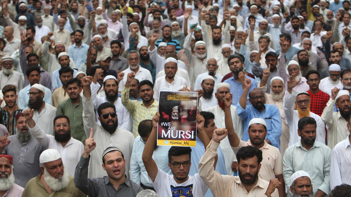 Supporters of the Pakistani religious party Jamaat-i-Islami, gather to offer a funeral prayer in absentia for ousted former Egyptian President Mohammed Morsi, in Karachi, Pakistan. Tuesday, June 18, 2019.