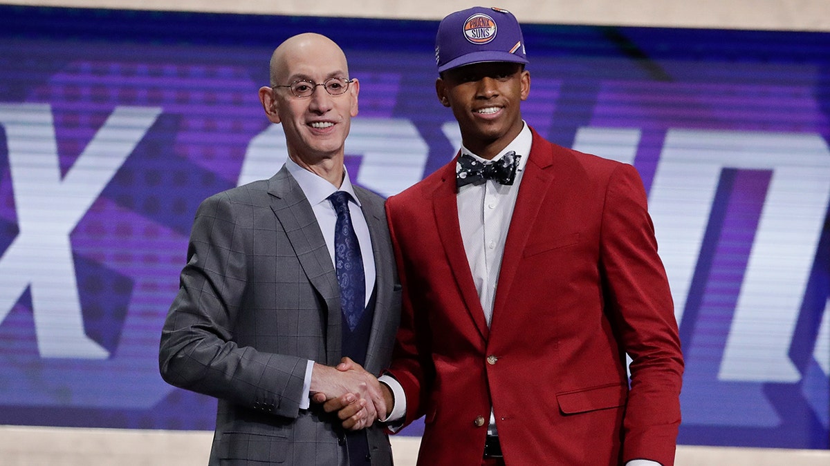 NBA Commissioner Adam Silver poses for photographs with Texas Tech's Jarrett Culver after the Phoenix Suns selected him as the sixth pick overall in the NBA basketball draft Thursday, June 20, 2019, in New York. (AP Photo/Julio Cortez)