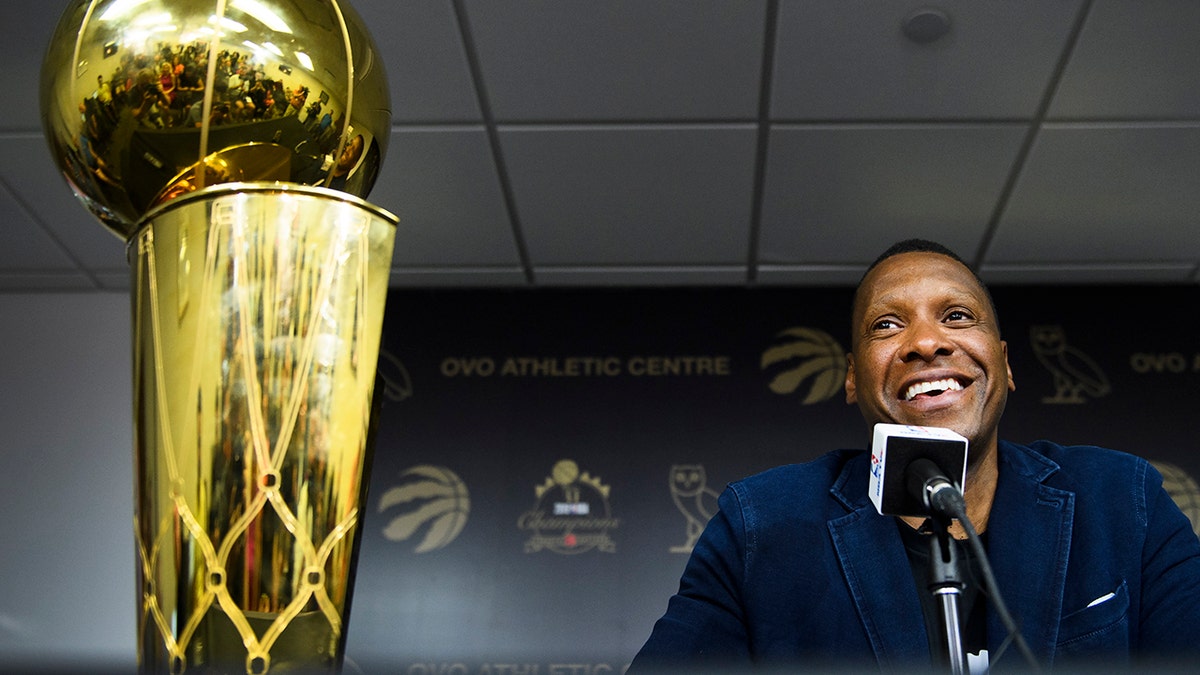 Toronto Raptors NBA basketball team president Masai Ujiri speaks to the media during an end-of-season press conference in Toronto, Tuesday, June 25, 2019. At left is the Larry O'Brien Trophy. (Nathan Denette/The Canadian Press via AP)