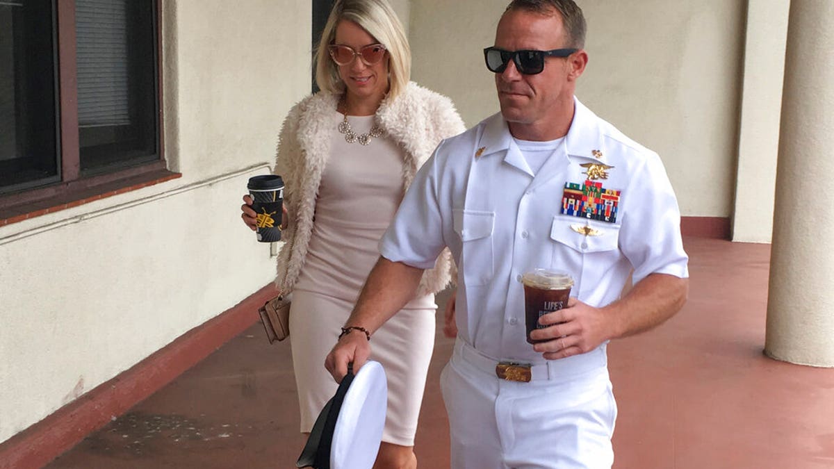 Navy Special Operations Chief Edward Gallagher, right, walks with his wife, Andrea Gallagher as they arrive to military court on Naval Base San Diego, Monday, June 24, 2019, in San Diego. (AP Photo/Julie Watson)