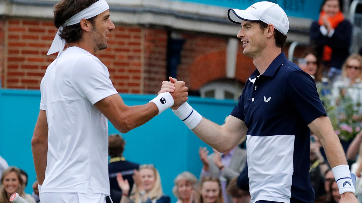 Andy Murray of Britain celebrates with Feliciano Lopez of Spain winning their doubles match against Juan Sebastian Cabal and Robert Farah of Colombia at the Queens Club tennis tournament in London, Thursday, June 20, 2019.(AP Photo/Frank Augstein)