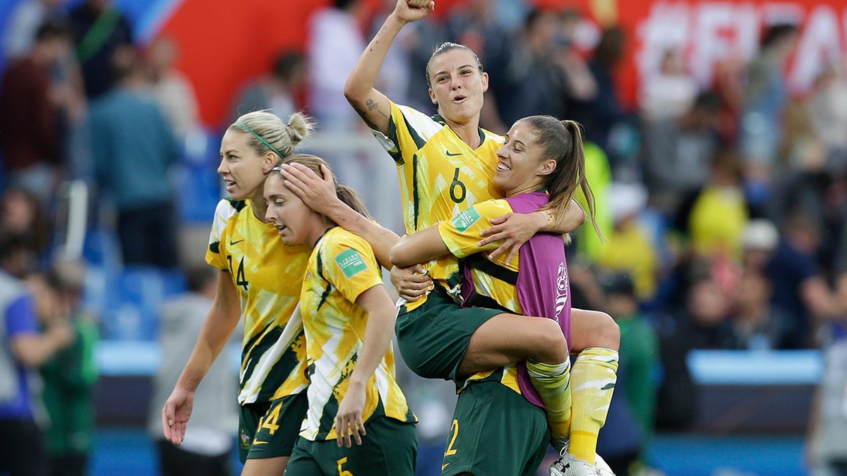 Australia's Chloe Logarzo, top, celebrates with a teammate at the end of the Women's World Cup Group C soccer match between Australia and Brazil at Stade de la Mosson in Montpellier, France, Thursday, June 13, 2019. Australia defeated Brazil 3-2. (AP Photo/Claude Paris)