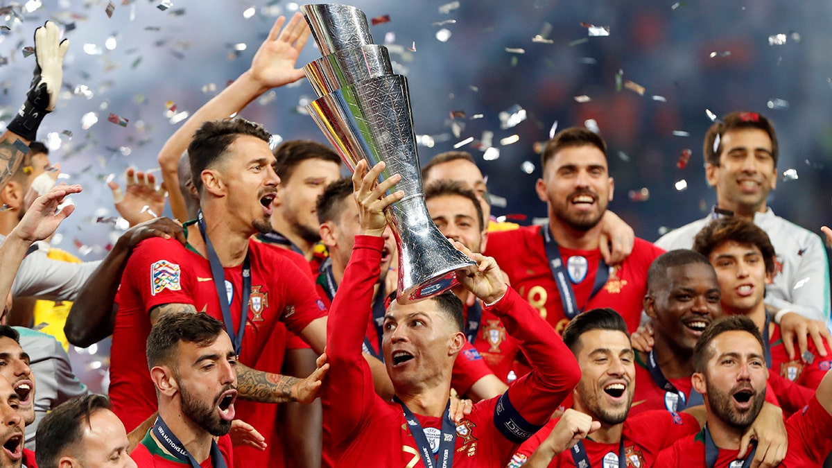 Portugal players celebrate with their trophy after defeating the Netherlands 1-0 in the UEFA Nations League final soccer match at the Dragao stadium in Porto, Portugal, Sunday, June 9, 2019. (AP Photo/Armando Franca)